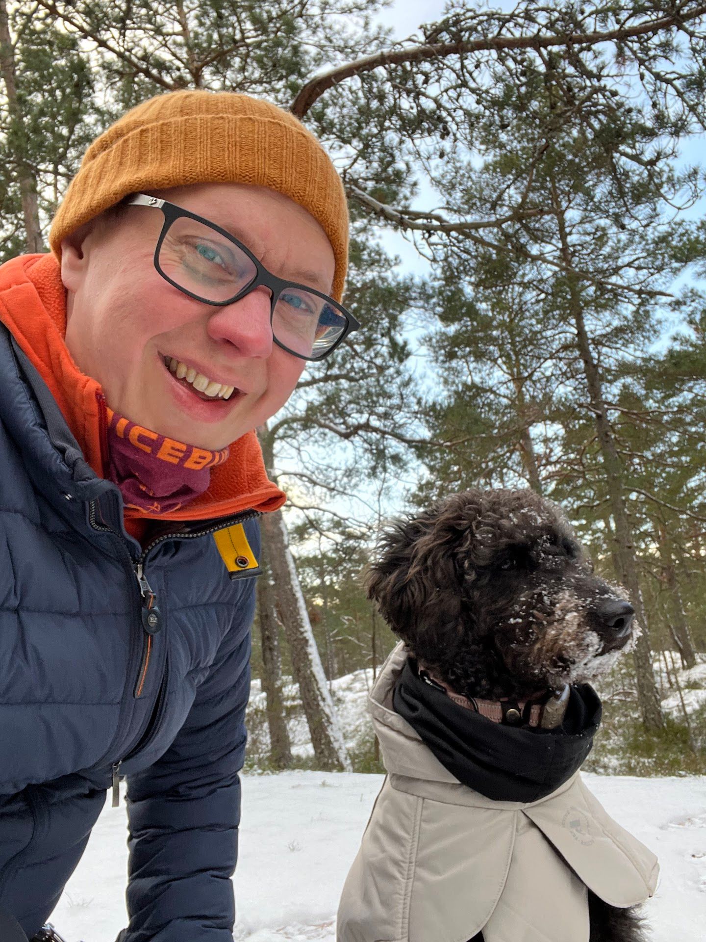 A snowy image of Fredrik and his black labradoodle Freja